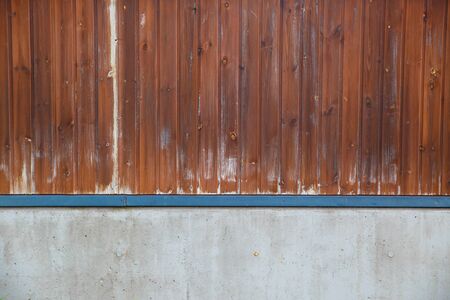 Old brown wooden wall, detailed background photo texture. Wood plank fence close up and grunge cement floor texture background.の写真素材