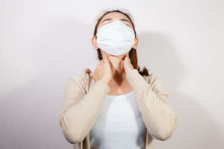 Woman wearing face mask protect filter pm2.5 anti pollution on white background, anti smog and protect her from virus. Air pollution, Coronavirus pandemic, environmental concept.の写真素材