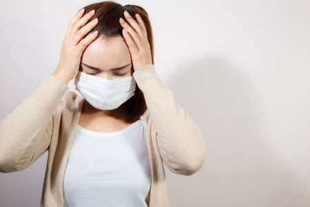 Woman wearing face mask protect filter pm2.5 anti pollution on white background, anti smog and protect her from virus. Air pollution, Coronavirus pandemic, environmental concept.の写真素材