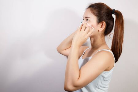 The image face of a young Asian woman wearing a mask to prevent germs, toxic fumes, and dust....