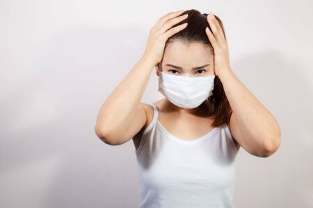 The image face of a young Asian woman wearing a mask to prevent germs, toxic fumes, and dust....