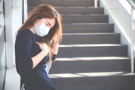 Virus mask Asian woman travel wearing face protection in prevention for coronavirus. Sick woman in public space bus station or airport. Air pollution, Coronavirus pandemic, environmental concept.の写真素材
