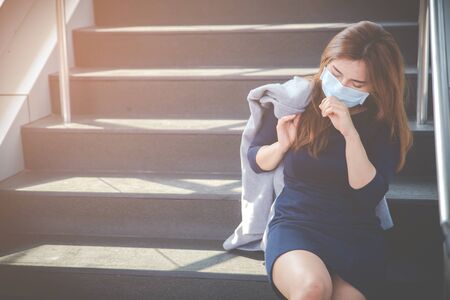 Virus mask Asian woman travel wearing face protection in prevention for coronavirus. Sick woman in public space bus station or airport. Air pollution, Coronavirus pandemic, environmental concept.の写真素材