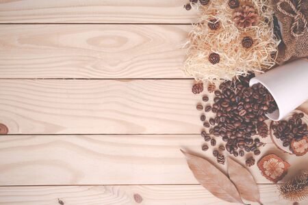 Autumn Flat lay composition. Cup of coffee, coffee beans, autumn dry leaves on wooden brown...