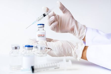Development and creation of a coronavirus vaccine COVID-19. Coronavirus Vaccine concept in hand of doctor white vaccine jar. Vaccine Concept of fight against coronavirus. Healthcare And Medical concept.の写真素材
