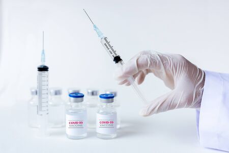 Development and creation of a coronavirus vaccine COVID-19. Coronavirus Vaccine concept in hand of doctor syringe. Vaccine Concept of fight against coronavirus. Healthcare And Medical concept.の写真素材