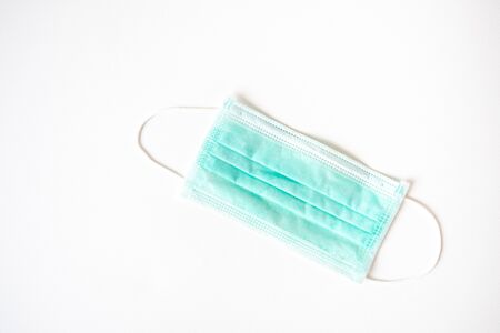 Coronavirus COVID-19 pandemic. Antiviral medical mask for protection against corona virus. Surgical protective mask. Medical respiratory bandage face on white background. quarantine, stay at homeの写真素材