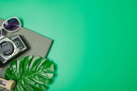 The beach accessories on the green background. Summer is coming concept. vacation and travel concept. copy space.の写真素材