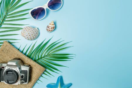 The beach accessories on the blue background. Summer is coming concept. vacation and travel concept. copy space.の写真素材