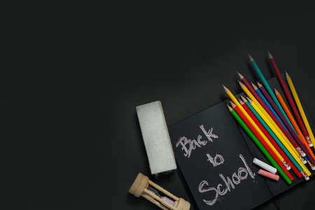 School supplies on black board background. Back to school concept.の写真素材