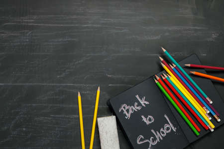 School supplies on black board background. Back to school concept.の写真素材