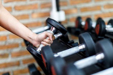Sporty young woman doing yoga practice in the gym - concept of healthy life and natural balance between body and mental development.の写真素材