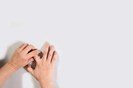 Woman hand scratching on feet isolated on white background for healthy concept.の写真素材