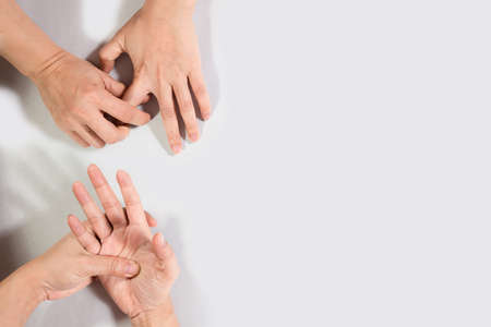Woman hand scratching on feet isolated on white background for healthy concept.の写真素材