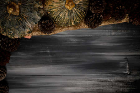 Fall Thanksgiving and Halloween pumpkins, leaves, acorn squash over dark wood table background shot from directly above.の写真素材