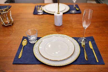 Beautifully laid tables with glasses and appliances at morning in restaurant.の写真素材