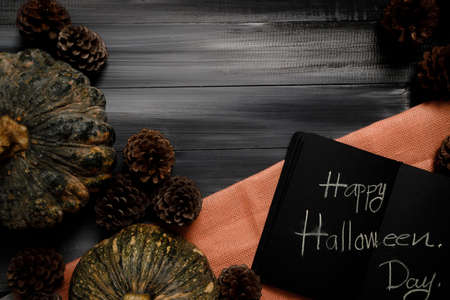 Fall Thanksgiving and Halloween pumpkins, leaves, acorn squash over dark wood table background shot from directly above.の写真素材