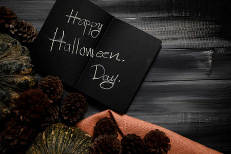 Fall Thanksgiving and Halloween pumpkins, leaves, acorn squash over dark wood table background shot from directly above.の写真素材