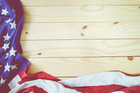 Close up of waving national usa american flag on wooden background with copy space for text.の写真素材