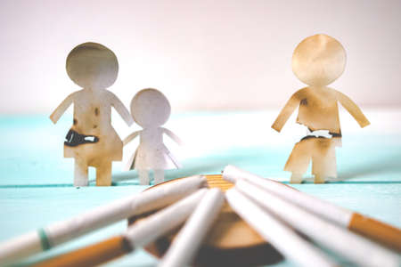 Paper cut of family destroyed by cigarettes. Drugs destroying family concept. Quit smoking for life on World no Tobacco day concept. World no tobacco day.の写真素材