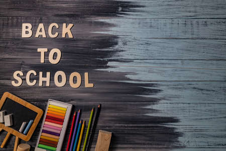 School supplies on black board background. Back to school concept.の写真素材