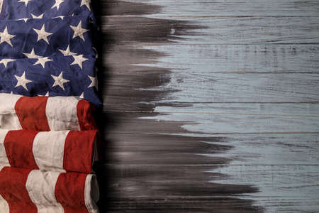Close up of waving national usa american flag on wooden background with copy space for text.の写真素材
