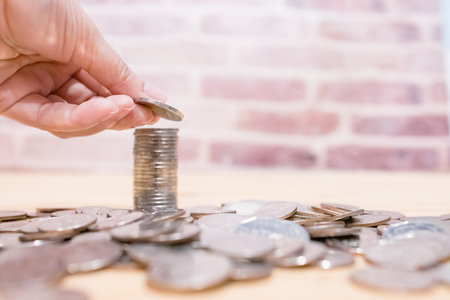 Images of growing stacking coins and Hand holding coin for planning step up and savings, Saving money for future plan and retirement fund concept. Concept saving money for finance accounting.の写真素材