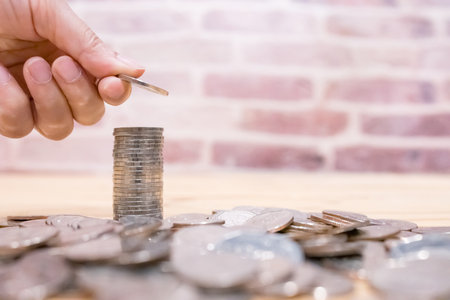Images of growing stacking coins and Hand holding coin for planning step up and savings, Saving money for future plan and retirement fund concept. Concept saving money for finance accounting.の写真素材