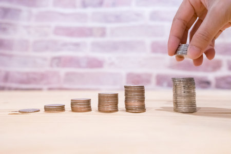 Images of growing stacking coins and Hand holding coin for planning step up and savings, Saving money for future plan and retirement fund concept. Concept saving money for finance accounting.の写真素材