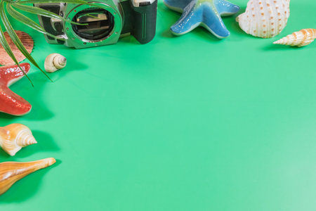 The beach accessories on the green background. Summer is coming concept. vacation and travel concept. copy space.の写真素材