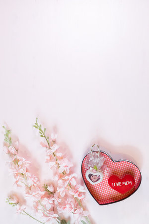 Everyday is mother's day. Mother's day concepts and Sweetest day, love concept. Red heart with the letter LOVE MOM with Beautiful flower on pink background.の写真素材