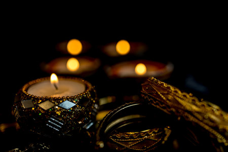 Happy Diwali - Clay Diya lamps lit during Dipavali, Hindu festival of lights celebration. Colorful traditional oil lamp diya on dark background. Copy space for text.の写真素材