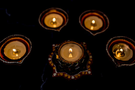 Happy Diwali - Clay Diya lamps lit during Dipavali, Hindu festival of lights celebration. Colorful...