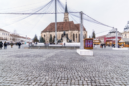 winter night scenery city square with Christmas tree and holiday market. Cluj Napoca