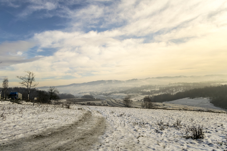hills covered with fog in winterの写真素材
