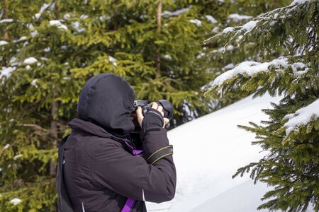 Woman Photographer Hiker In Snowy Mountain, In Search Of Best Picture to Take
