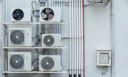 outdoor air conditioner multiple air compressors Installed outside stacked neatly for coolingの写真素材