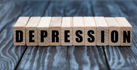 DEPRESSION word on cubes on a beautiful gray blue background. Business conceptの写真素材