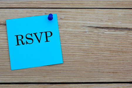 RSVP is an acronym written on a blue sheet attached to a wooden board. Holiday conceptの写真素材