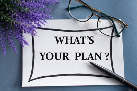 WHAT'S YOUR PLAN? - words on a white sheet against the background of glasses, pens and lavender. Business conceptの写真素材