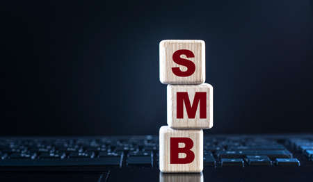 SMB (Server Message Block) - acronym on wooden cubes on the background of the laptop keyboard....