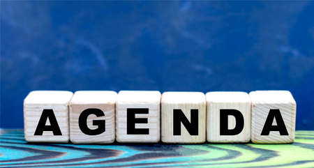 concept word agenda on cubes on a beautiful blue backgroundの写真素材