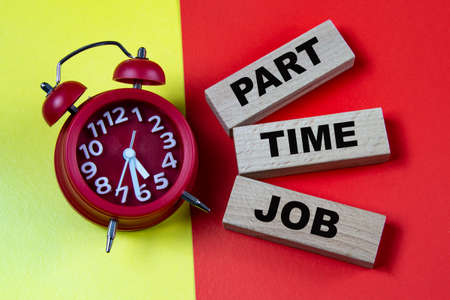 PART TIME JOB - words on colorful background with alarm clock. Business conceptの写真素材
