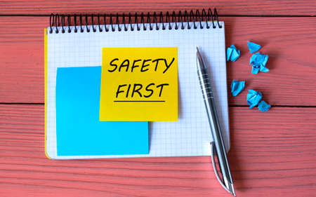 .SAFETY FIRST - words on a note sheet on a pink background with a pen. Info conceptの写真素材