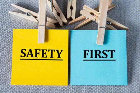 SAFETY FIRST - words on multicolored writing paper on gray background with clothespins. Education conceptの写真素材