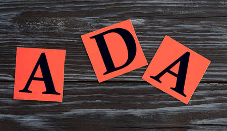ADA written in red squares on a dark beautiful background. Business conceptの写真素材