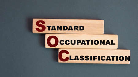 SOC (Standard Occupational Classification) - acronym on wooden bars on a gray background. Info conceptの写真素材