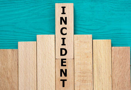 Incident - word on wooden bars on a green background. Info conceptの写真素材