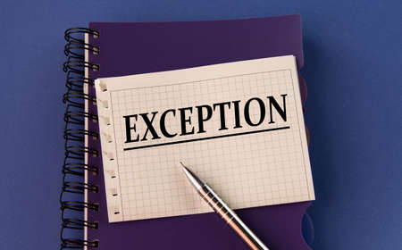 EXCEPTION - word word on a white sheet with a pen on the background of a purple notepad. Info...