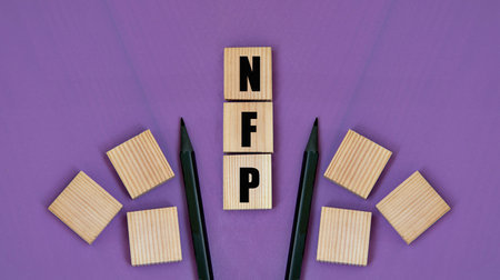 NFP (Natural Family Planning) - acronym on wooden cubes with pencils on a purple backgroundの写真素材